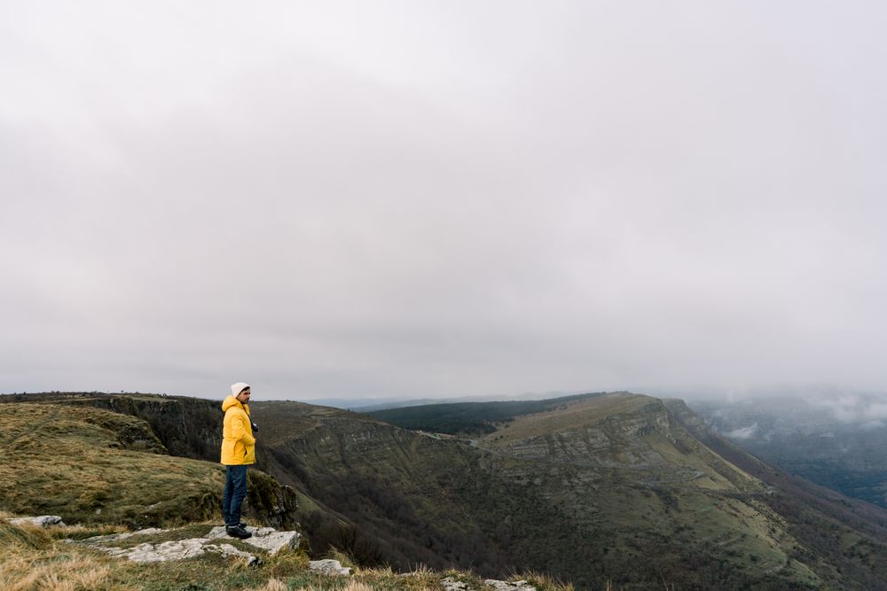 Man standing on top of hill