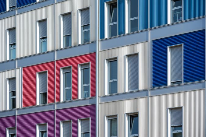Facade of modern multicolored building with narrow windows
