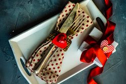 St. Valentine day table setting with dotted napkin on plate