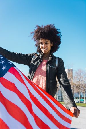 Black woman with afro hair and an american flag