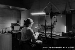 Back view of woman working in a lab in grayscale 4dDnr4