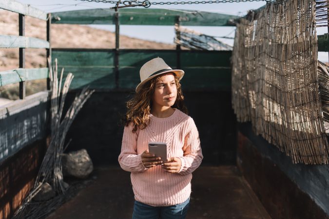 Focused girl using smartphone in countryside