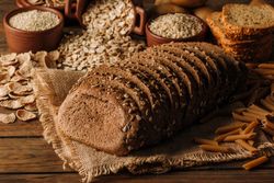 Freshly baked rye bread on napkin on table