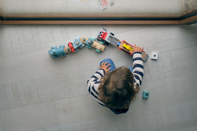 Unrecognizable child playing with toys