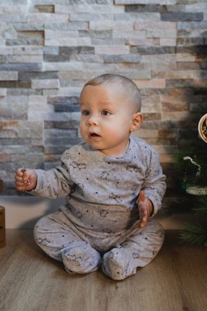 Cute baby playing with Christmas tree baubles