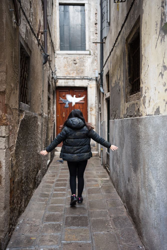 Anonymous woman strolling on rocked alley