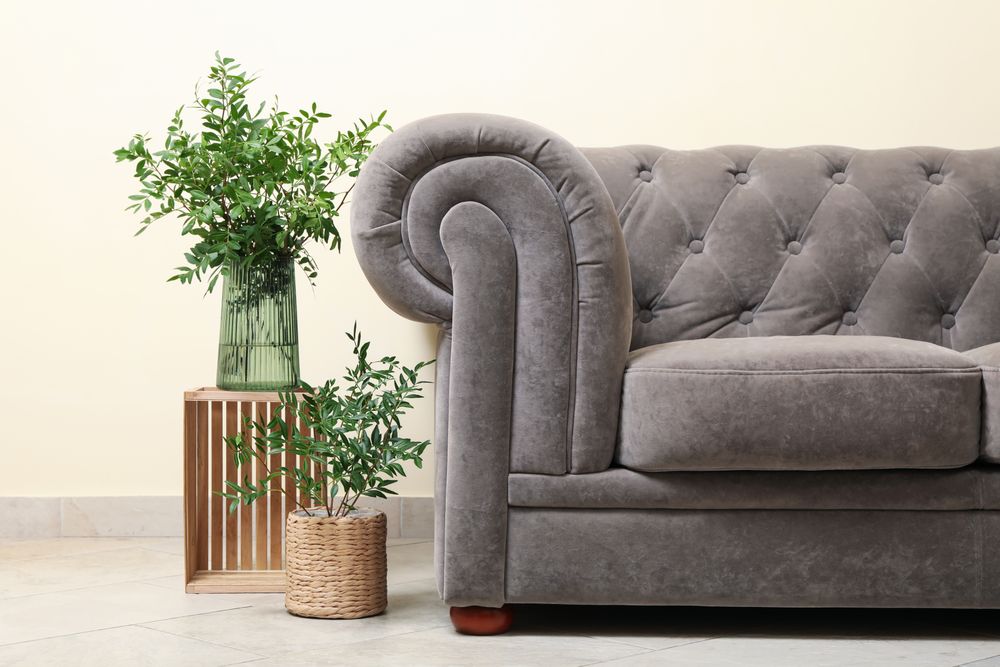 Simple interior with sofa against light beige wall