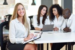 Smiling female business leader smiling in office looking at camera