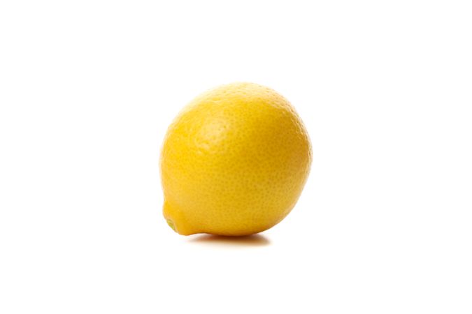 Fresh lemon isolated on light background. Ripe fruit