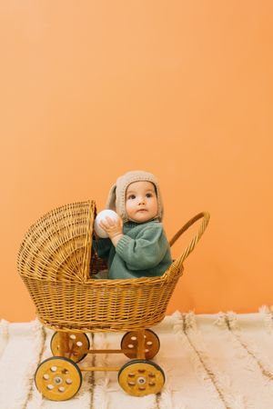 Cute baby in wicker carriage