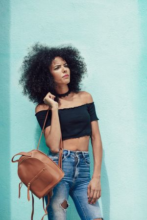 Female wearing casual clothes with turquoise background