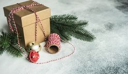 Christmas gift on counter with red string and ornaments