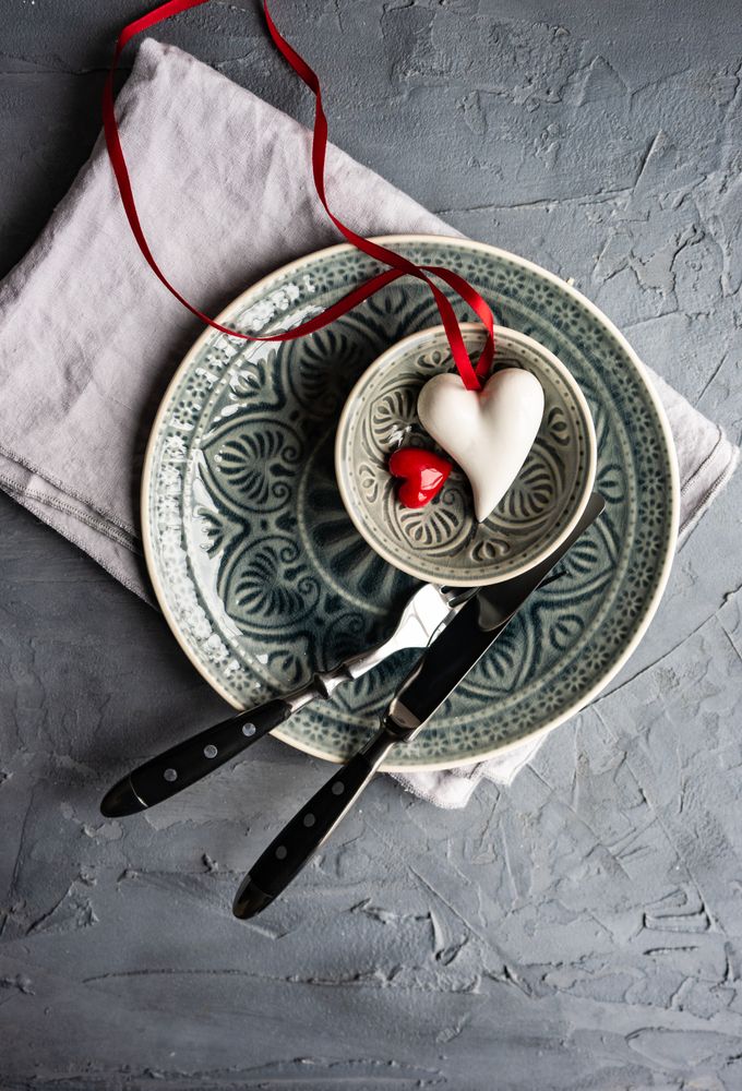 Ornate table setting with heart decorations and cutlery
