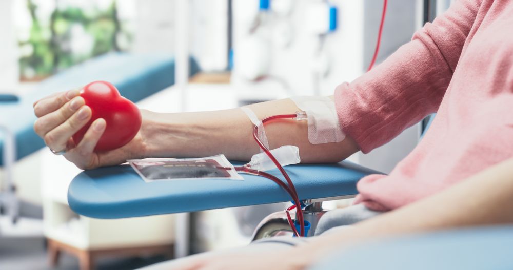 Close Up Shot Of Hand Of Female Blood Donor With an Attached Catheter.