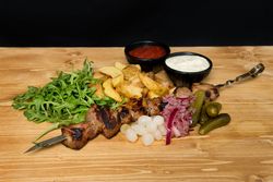 Fried meat and vegetables near ketchup