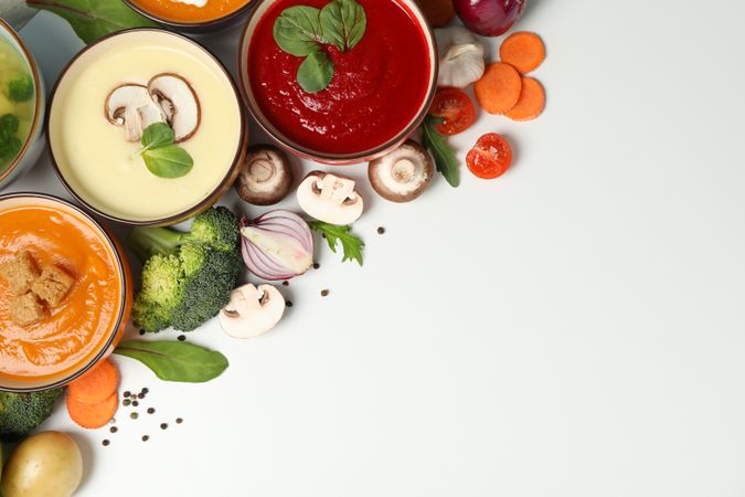 Colorful soups in top corner of picture with copy space