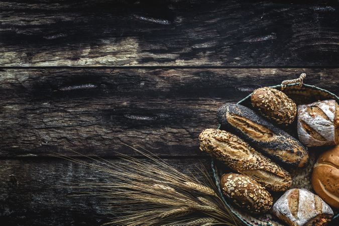 Assorted gold homemade bread on dark wood background