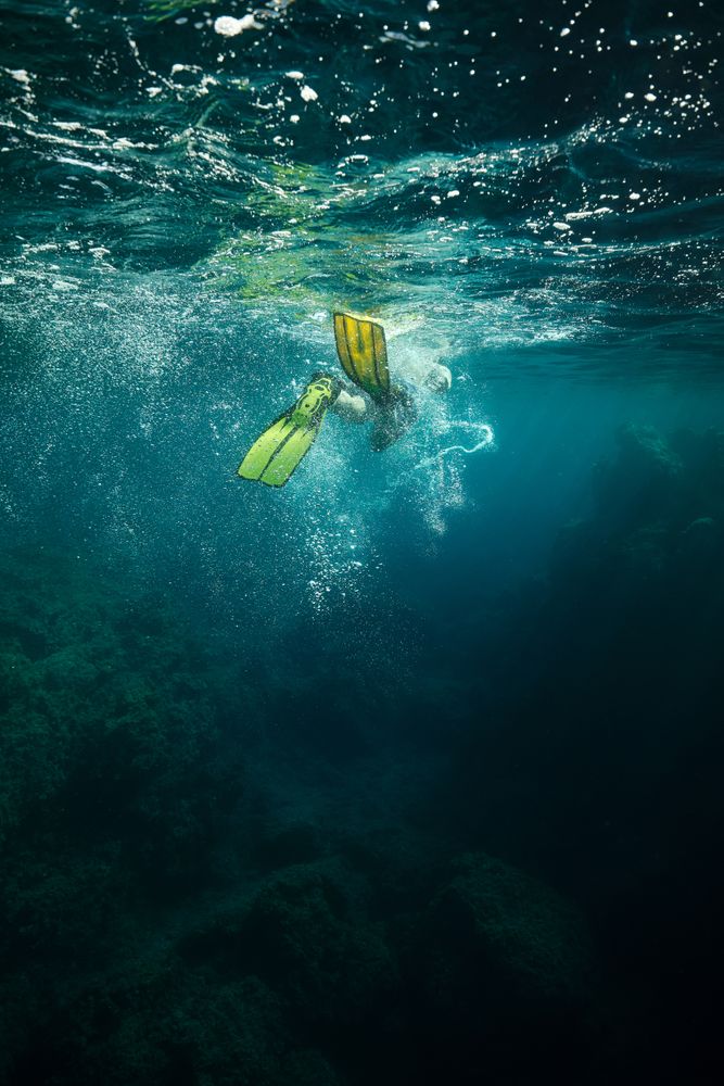 Diver swimming under water in flippers