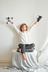 Excited preteen boy rejoicing gifted drone with remote control