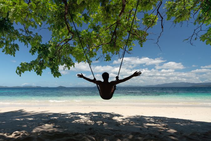 Tourist relaxing on beautiful tropical island