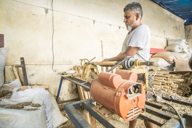 Man using woodworking machine at workplace