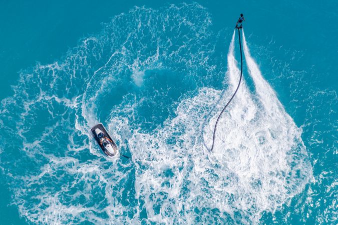 Overhead shot of person jet blading and another on a jet ski