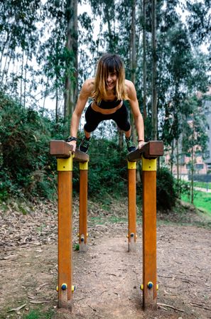 Athlete woman training on parallel bars