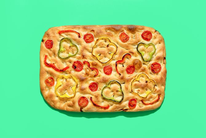 Vegan focaccia above view, minimalist on a green background