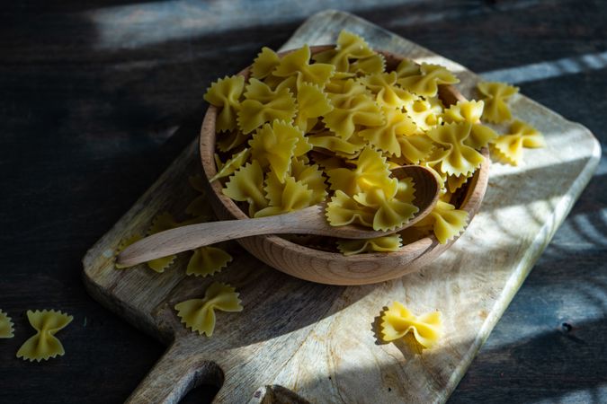 Farfalle pasta in wooden bowl on kitchen counter
