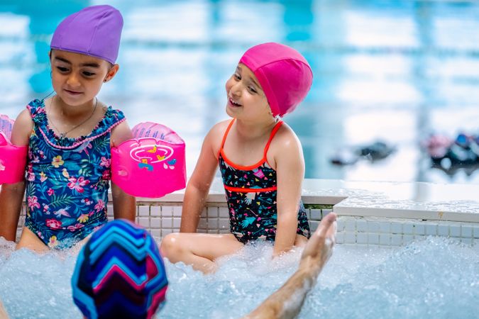 girls with water wings in swimming pool