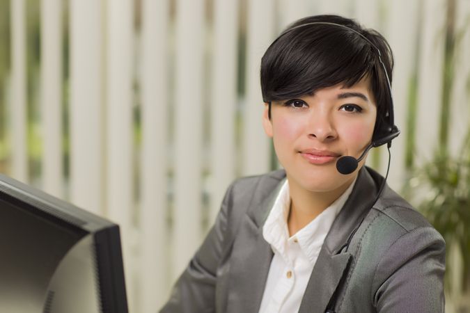 Young Woman Smiles Wearing Headset