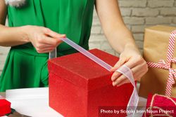 Woman packing red gift box 4mG3B0