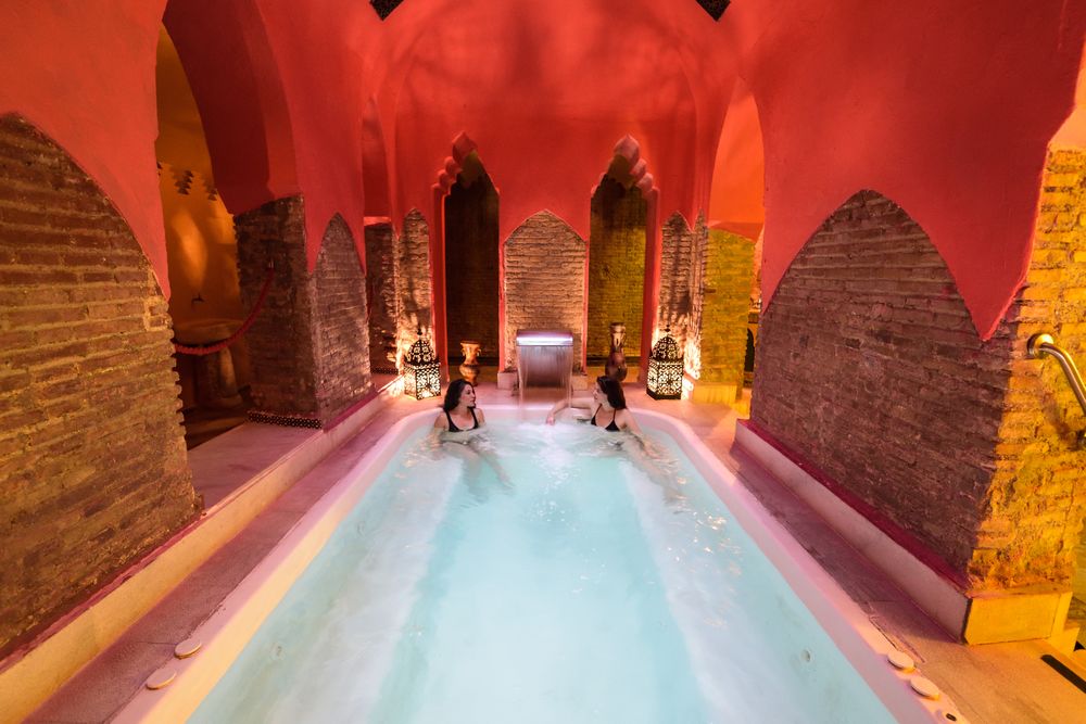 Two women in a spa with Arabic theme and red decor