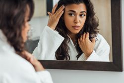 Woman checking her hair in the mirror