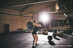 Woman heavy lifting in spacious gym 5rM2M0