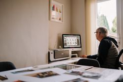 Man working in his home office working on a computer