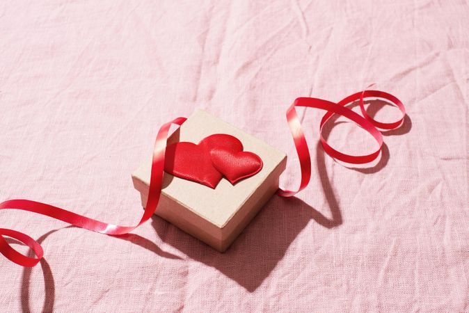 Small gift box with red heart and ribbon