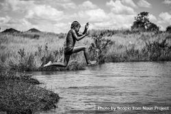 Grayscale photo of boy jumping on water bewYq5