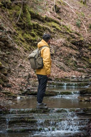 Unrecognizable traveler standing on cascade