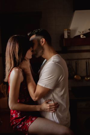 Happy couple kissing in kitchen