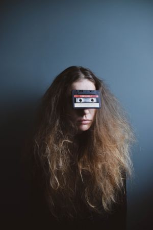 Portrait of woman with cassette on her eyes