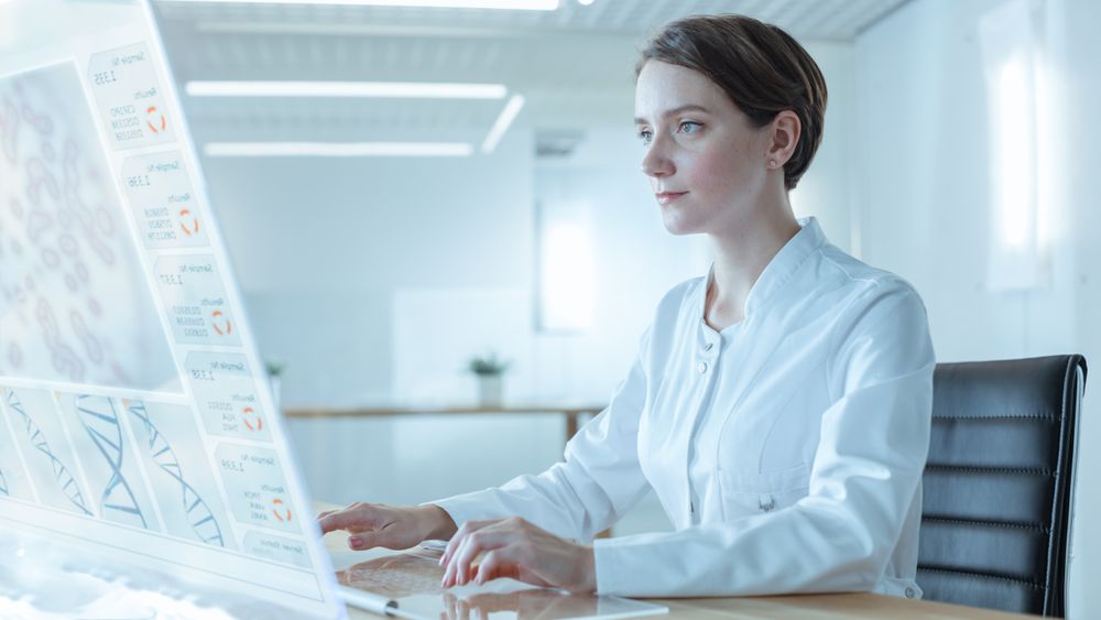 Portrait Shot of a Female Scientists Working on the Transparent Display Computer In the Futuristic Laboratory.