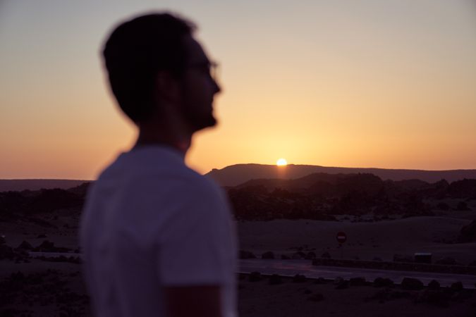 Tourist enjoying sunset in nature