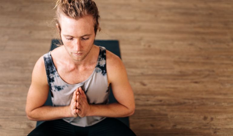 Fitness guy doing yoga meditation