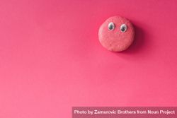 French macaron with googly eyes bright pink background 5kpdG4