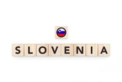 Wooden blocks bearing the name and flag of Slovenia. Sloven and East European Culture, national identity, travel, and geography in a copy space design.