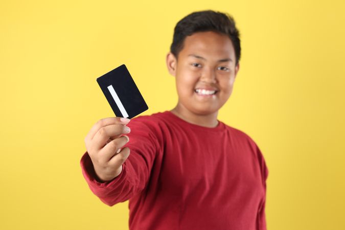 Asian Boy Holding Credit Card