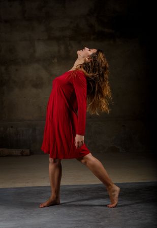 Young woman dancing in darkness