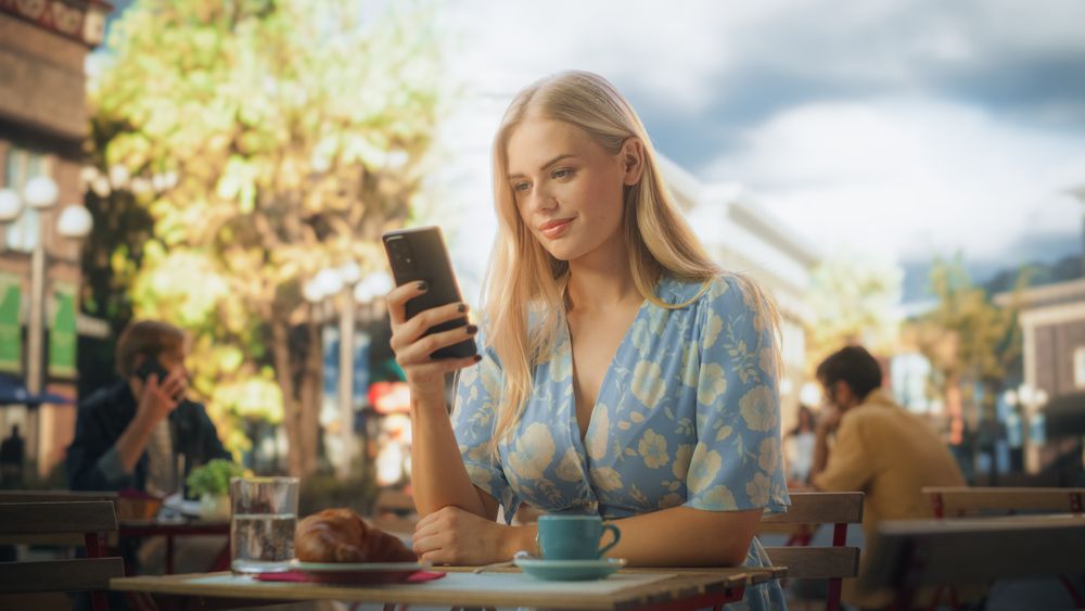 Young Woman Using Smartphone, Chatting with Friends Online