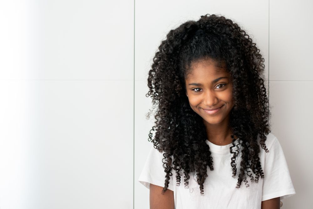 Portrait of a beautiful young Black teenage girl looking into camera